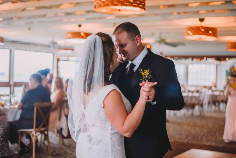 Husband and wife dancing at their wedding at the Tiffany Room at Capt Hirams Resort