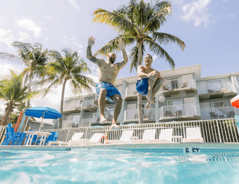 2 men jumping into the pool at Capt Hirams Resort