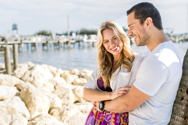 Man and women holding eachother by the beach at Capt Hirams Resort